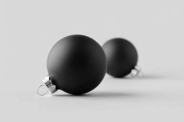 istock Two black matte Christmas balls mockup on a seamless grey background. 1287252719