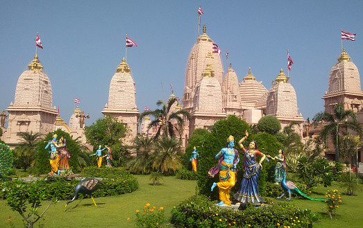 This image features the Radhagopinath Temple in Mumbai, a spiritual haven known for its serene ambience and beautiful architecture. The temple, dedicated to Lord Krishna and Radha, is a fine example of traditional Indian architecture with ornate carvings and intricate designs. The photograph captures the temple's detailed artwork and its structure's warm, welcoming hues. Nestled within the bustling city, the Radhagopinath Temple is a peaceful sanctuary, offering a place of worship and contemplation for devotees and visitors alike. The image aims to convey the temple's spiritual significance and its role as a centre for cultural and religious activities in Mumbai, highlighting its beauty and tranquillity amidst the urban landscape.