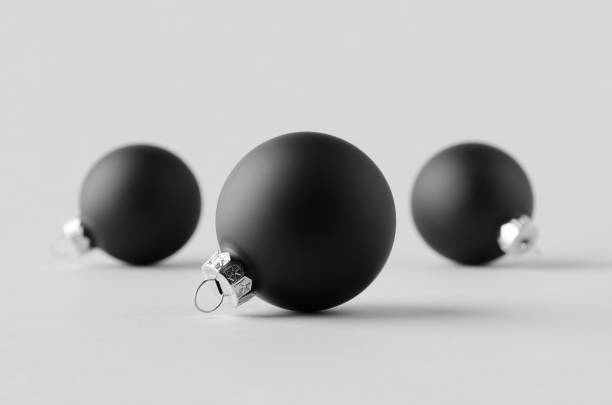 istock Three black matte Christmas balls mockup on a seamless grey background. 1287252927