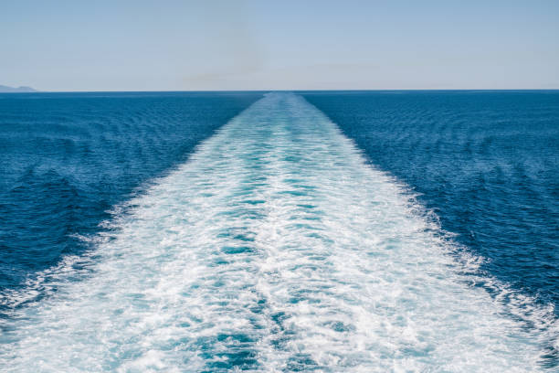 Wake in the Tyrrhenian Sea made by cruise ship Wake made by cruise ship in the Tyrrhenian Sea between Tuscany and Sardinia, italy wake water stock pictures, royalty-free photos & images