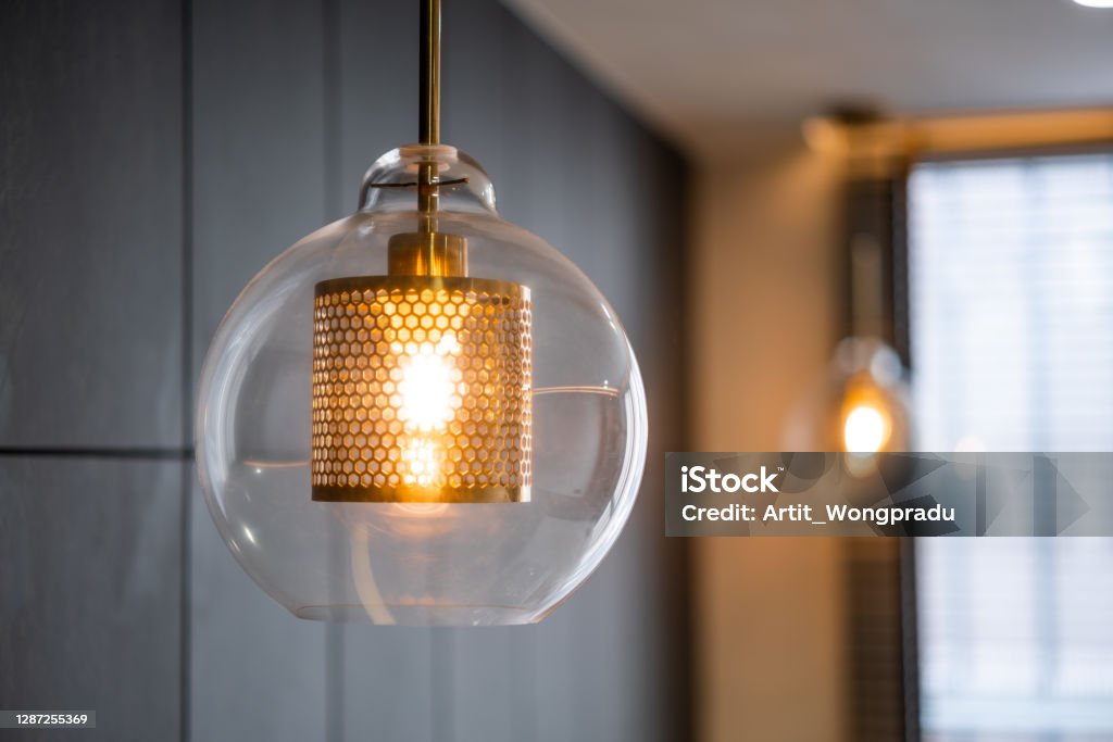 Vintage luxury interior lighting lamp cover with bronze plate and transparent glass bulb for home decor. Lighting Equipment Stock Photo