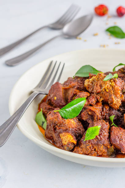 istock Indian Lamb Masala with Spoon and Fork Vertical Close-Up Photo 1287257779