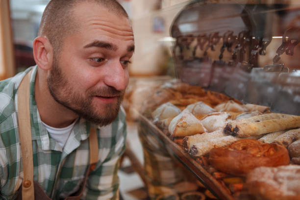 istock Young male baker working at his shop 1287259341