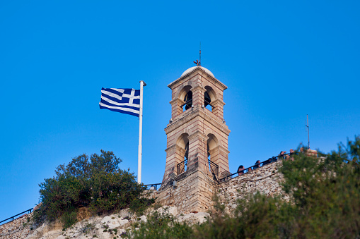 Athens, Greece - April 27 2019: Bell tower of the Church of Agios Georgios (Greek: Ιερός Ναός Αγίου Γεωργίου Λυκαβηττού) atop of the Mount Lycabettus.