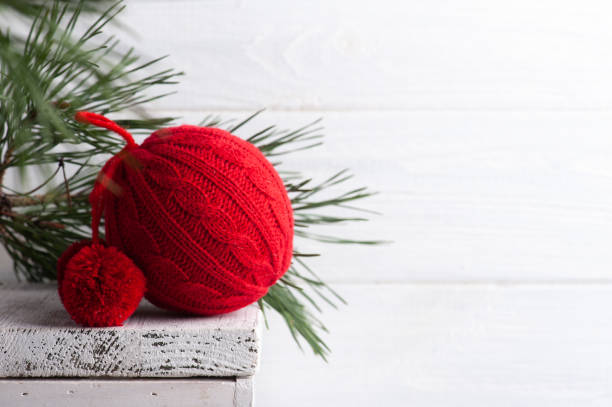 istock Red knit Christmas ball with pine tree 1287260799