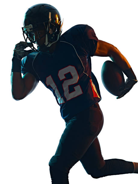 american football player man isolated white background one afro american football player man in studio silhouette shadow isolated on white background american football player studio stock pictures, royalty-free photos & images