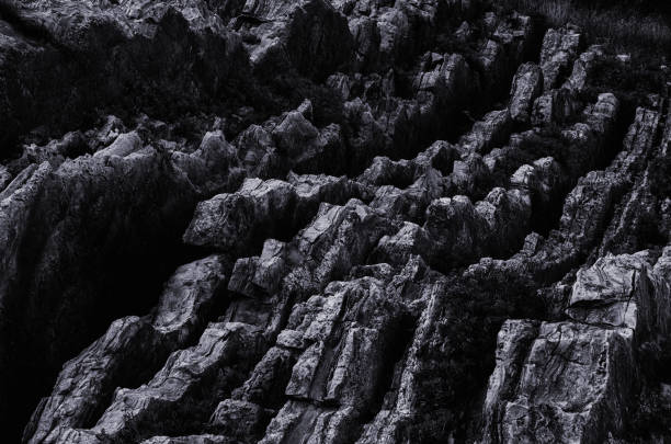 istock Dark Aged Shabby Cliff Face And Divided By Huge Cracks And Layers 1287262976