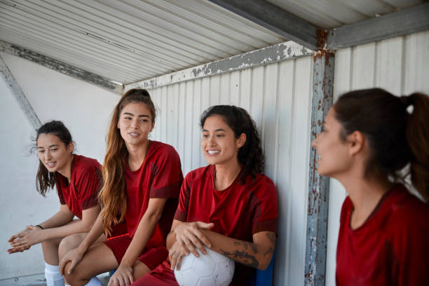 istock Female soccer team sitting on bench talking during practice 1287265187