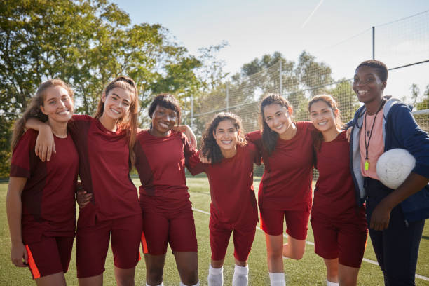 istock Female coach and soccer team smiling looking at camera 1287265316