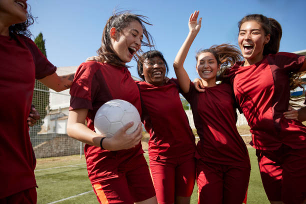 Group of soccer players celebrating huddled in circle Group of multi-ethnic soccer players celebrating huddled in circle after winning match sports activity stock pictures, royalty-free photos & images