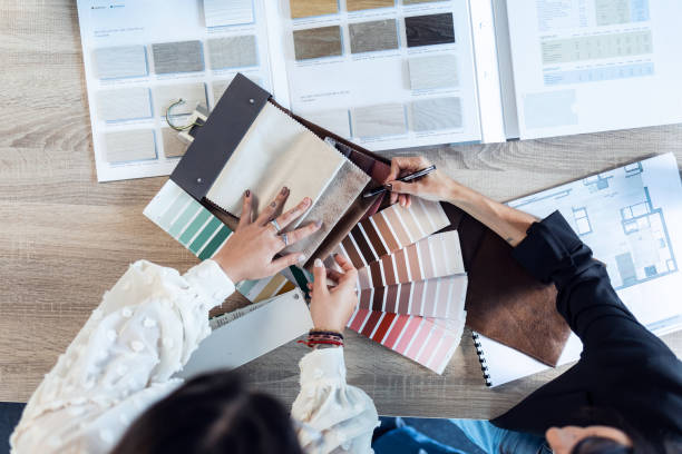 istock Two beautiful young designer women working in a design project while choosing materials in the office. 1287265448