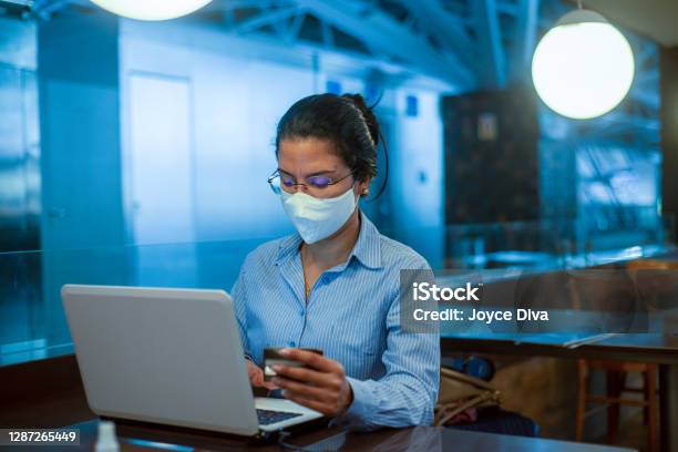 Woman Making Online Purchases Using Credit Card Stock Photo - Download Image Now - Mask - Disguise, Office, Working