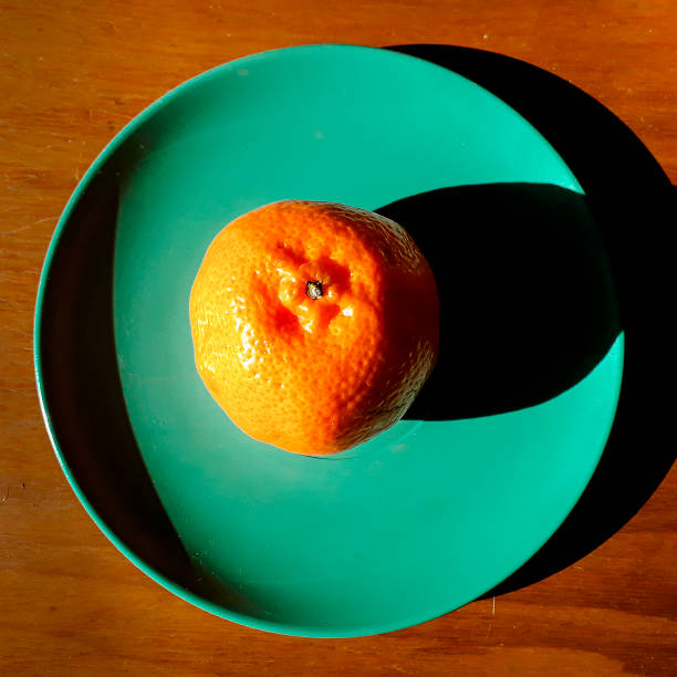 istock Tangerine on Green Small Plate Top View 1287266241