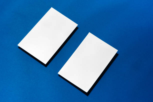 istock Two stacks of blank businesscards on blue background 1287266258