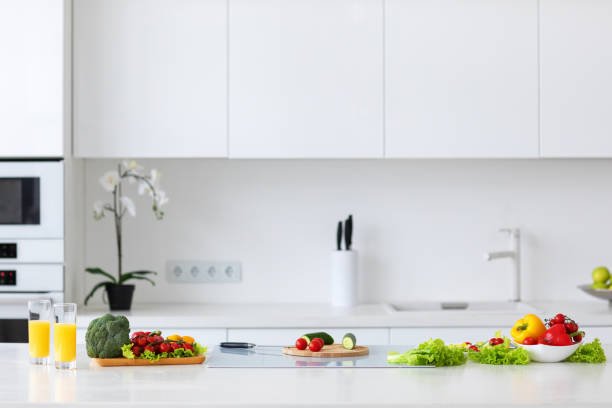 istock Classic kitchen with vegetables for preparing salad on the table 1287267834