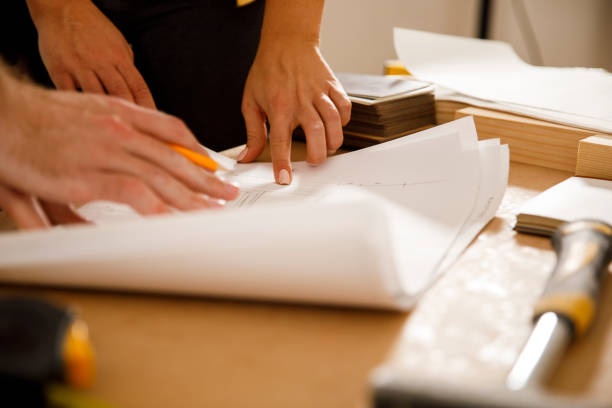 istock Checking out the plan drawings while renovating the apartment 1287268413