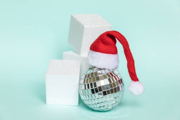 istock Simply minimal composition disco ball in Santa hat and cube shapes geometric form podium isolated blue pastel background. Christmas New Year december time for celebration concept. Mockup, copy space 1287268634