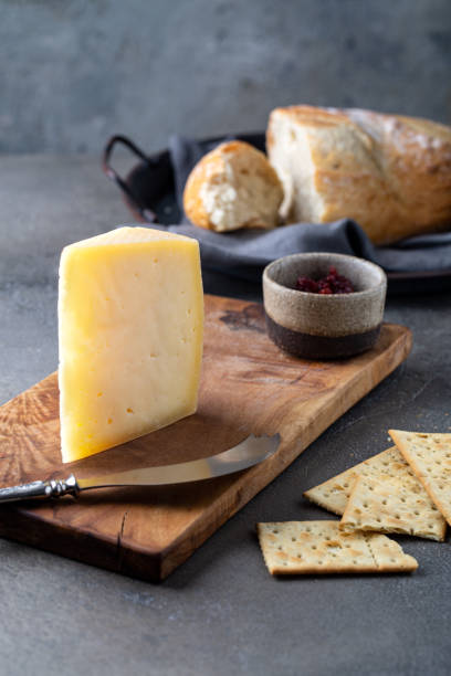 istock Peace of cheese sliced on a wooden board 1287269365