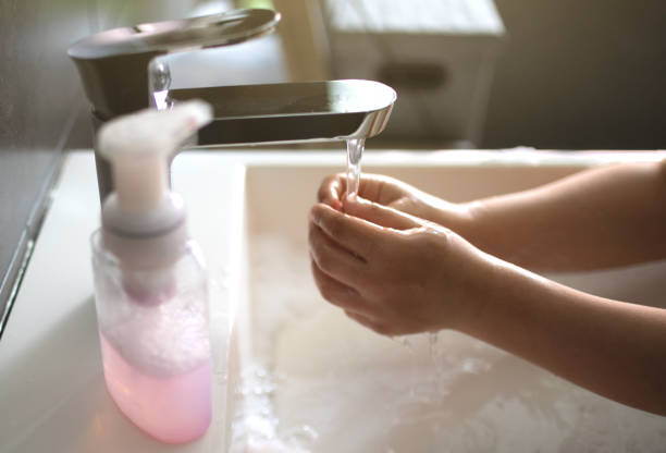 istock The child washes his hands with soap. 1287269558
