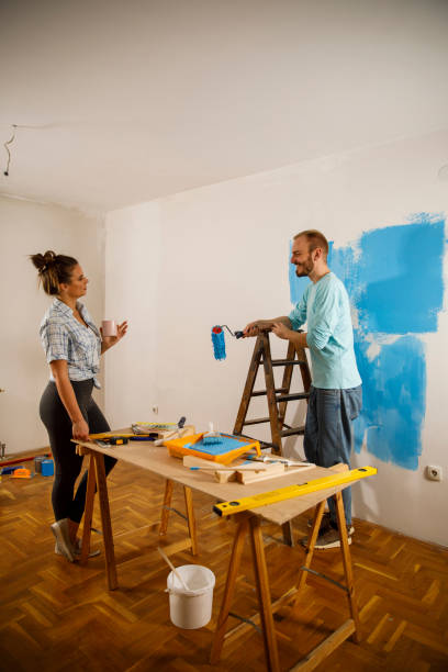 istock Young couple taking a break from renovations and talking 1287270052