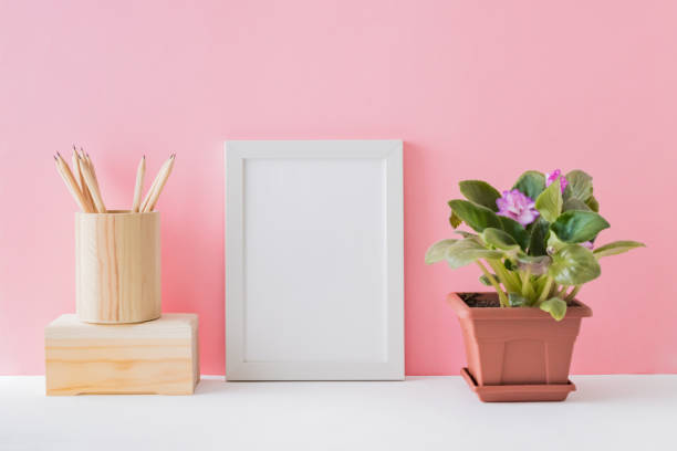 istock Home interior with decor elements. White frame, flowers in a pot, interior decoration 1287272009
