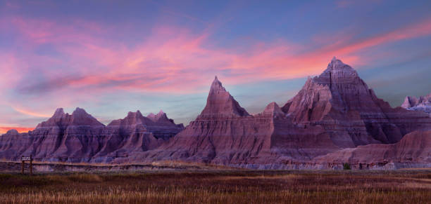 Panorama of the Eroded Landscape of Badlands National Park at Sunset Panarama of the Eroded Mountains of Badlands National Park, South Dakota During a Beautiful Pink Sunset badlands stock pictures, royalty-free photos & images