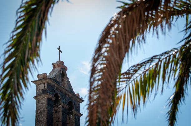 istock Cross hidden by the palm 1287273843