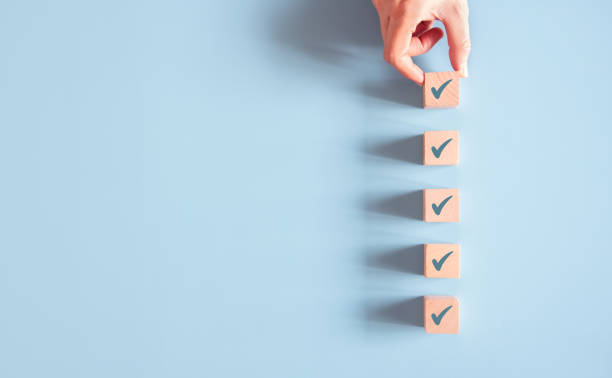 Wood cube with check mark on blue background, Checklist concept, Copy space. Wood cube with check mark on blue background, Checklist concept, Copy space. computer key photos stock pictures, royalty-free photos & images