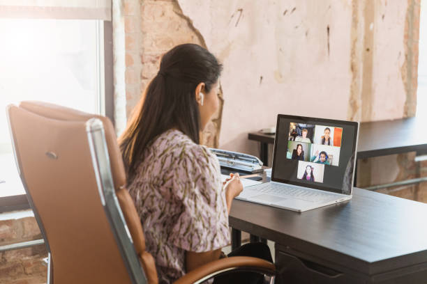 istock Teaching online because of COVID-19, teacher helps e-learners 1287276017