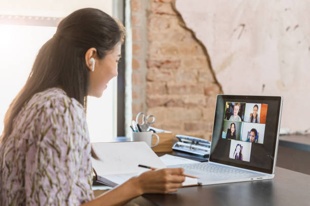 istock Female teacher enjoys video conferencing with students 1287276027