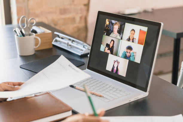 istock Unseen female tutor helps elementary age students online 1287276101