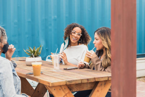 istock Diverse friends meet at open air restaurant for drinks 1287276544