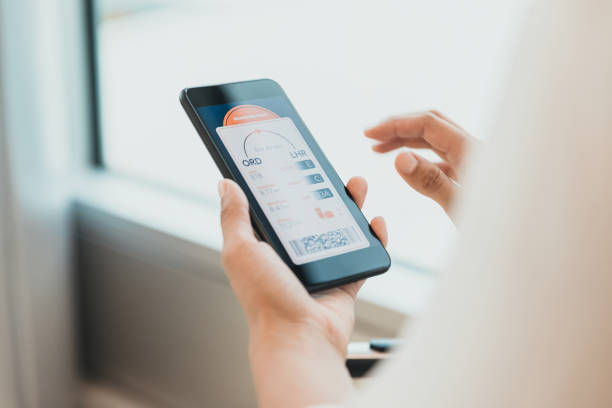 istock Unrecognizable woman loads boarding pass on smart phone 1287276699