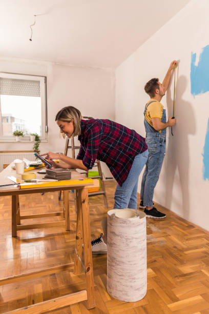 istock Preparing to apply wallpaper on walls during renovation 1287277142