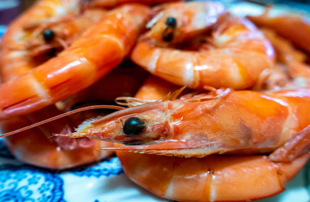 istock Close-up of some cooked shrimps served on a plate 1287279529