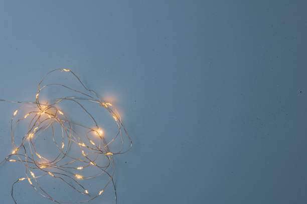 istock Decorated background with Christmas lights installation. Top view with copy space Christmas composition. 1287282552