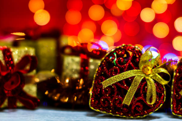istock Decorations and ornaments in a colorful Christmas composition isolated on background of blurred lights. 1287284551