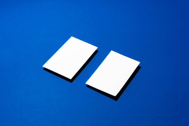 istock Two stacks of blank businesscards on blue background 1287284566