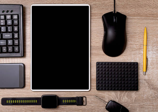 istock Tablet pc smartphone keyboard mouse and hard drive on a working wooden table as still life 1287285254