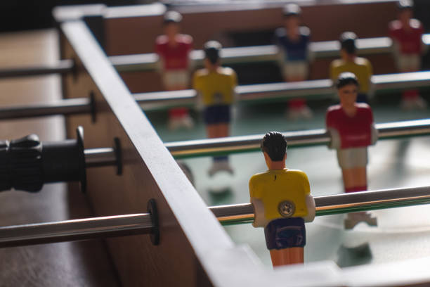 Table football with yellow and red kickers.