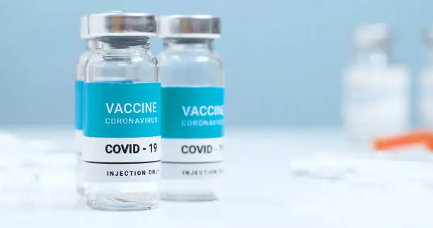 Measles, flu, coronavirus, covid 19 vaccine transparent liquid vials in laboratory. Testing and creating a new vaccine against the epidemic