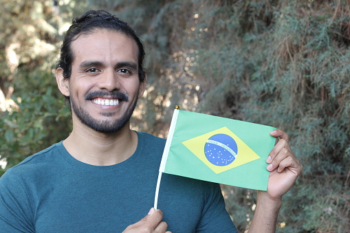 Brazilian man holding his flag.