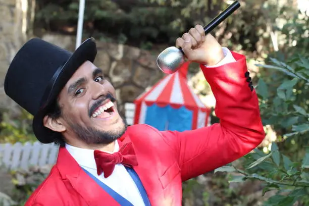 Photo of Charismatic ethnic ringmaster in the circus