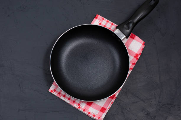 istock Empty black frying pan or skillet on a red checkered napkin 1287288323