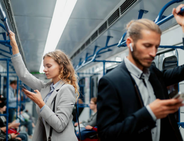 istock passengers using their smartphones in the subway car 1287289720
