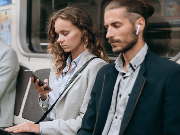 istock passengers with smartphones sitting in a subway car 1287289932