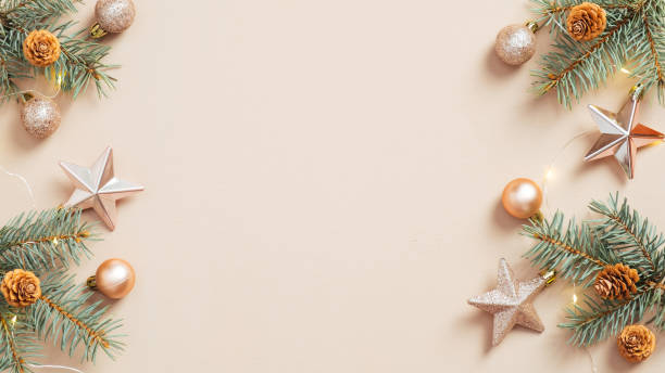 istock Christmas frame. Xmas tree branches decorated golden stars and balls on beige background. Flat lay, top view, copy space. Christmas banner mockup, poster template. 1287290519