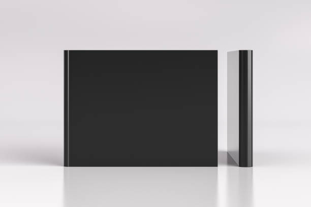 istock Two hardcover  horizontal or landscape black mockup books standing on the white background. Blank front cover and spine of book. 1287290901