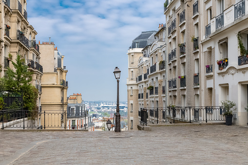 Paris, Montmartre, typical street with a vintage lamppost, beautiful buildings and staircase