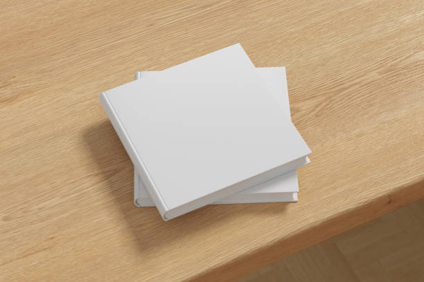 istock Square white hardcover book stack mockup on the wooden table. 1287292750
